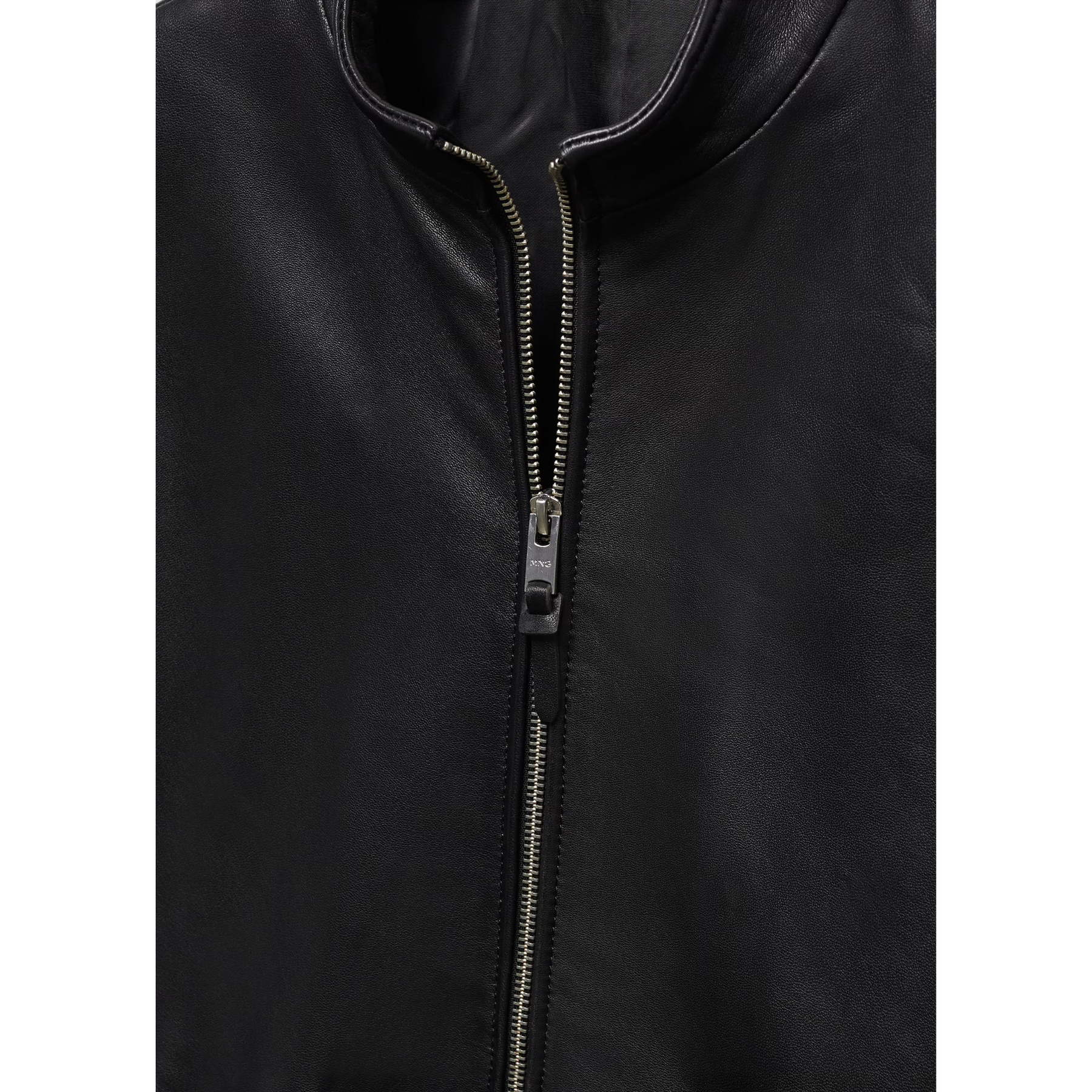 Close-up of zipper detail on black leather biker jacket.