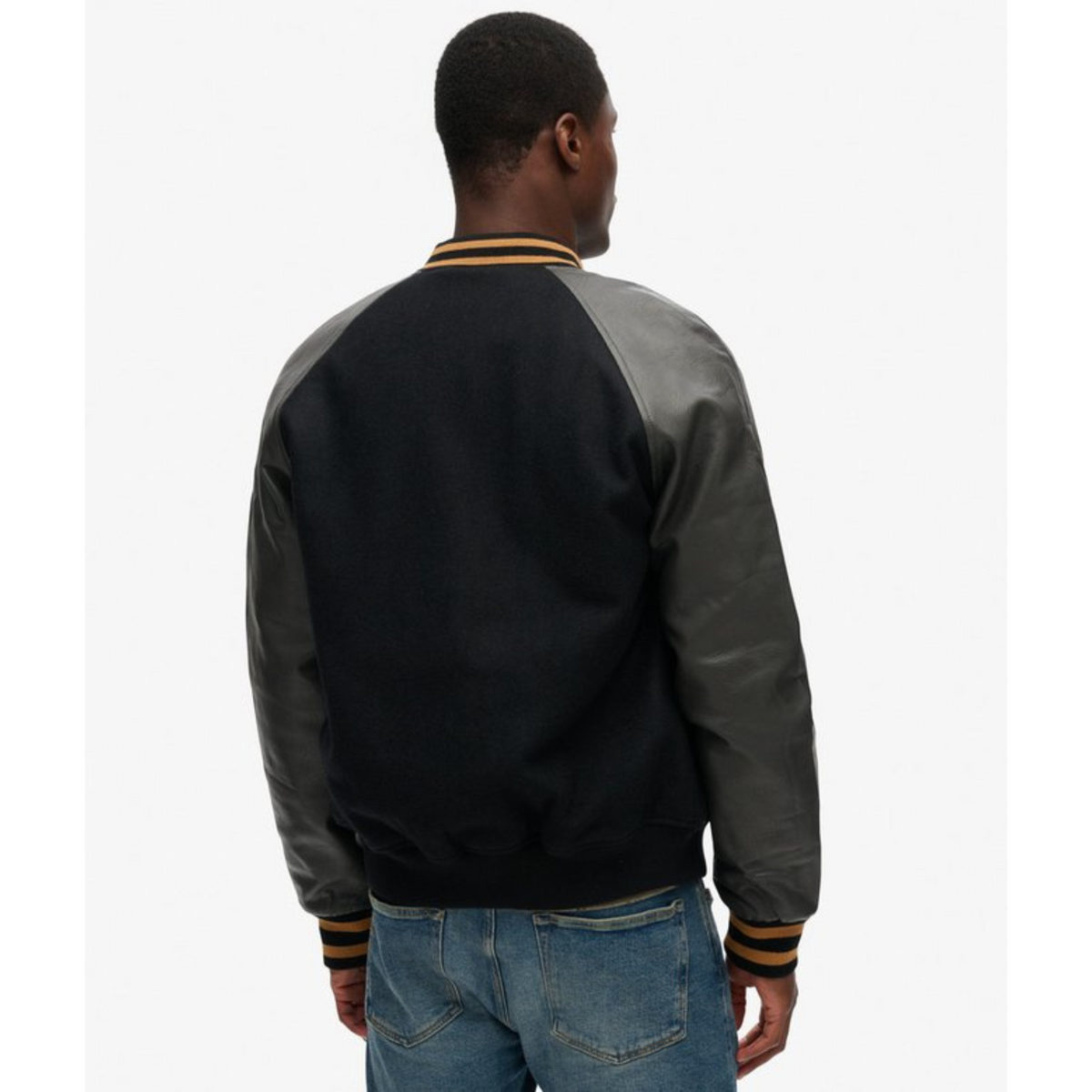 Back view of a black varsity jacket with leather sleeves