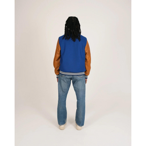 Model wearing blue varsity jacket back view