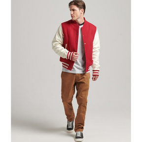 Full body front view of a man wearing a red varsity jacket with white sleeves, Alpha Apparel.