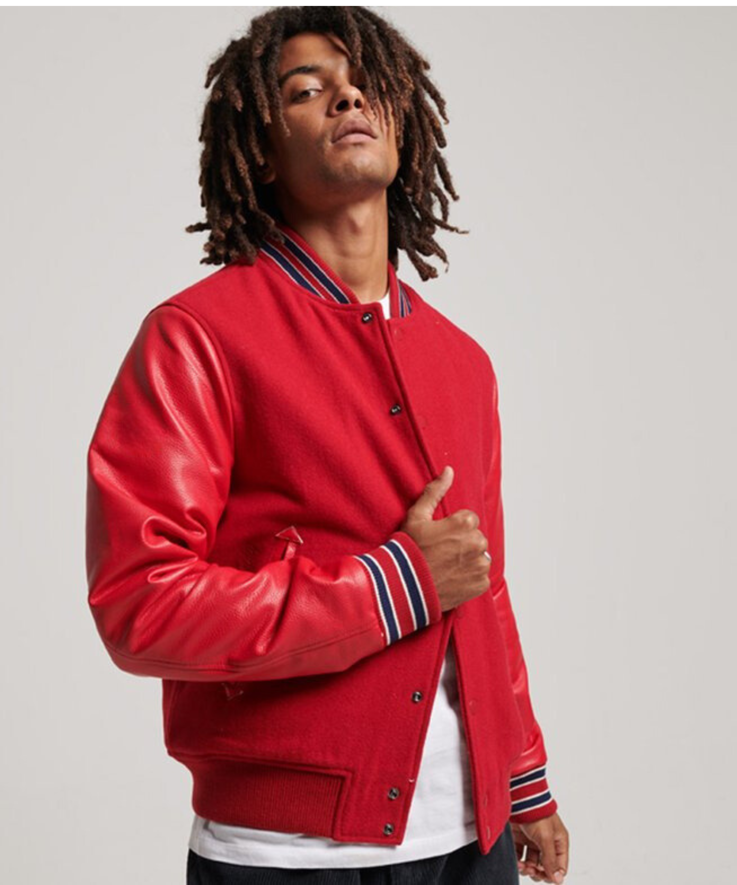 Man wearing a red varsity jacket with leather sleeves, gallery image by Alpha Apparel.