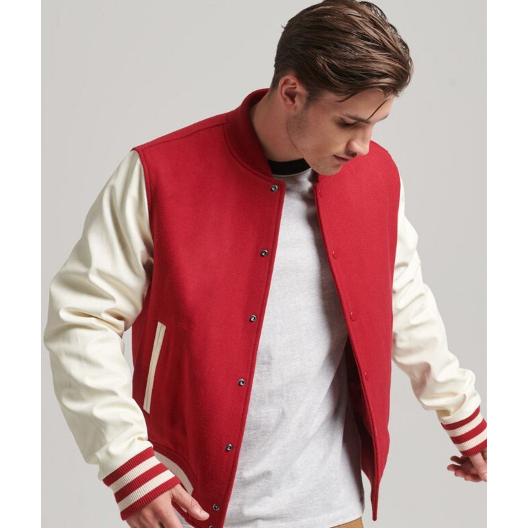 Front view of a men's red varsity jacket with white sleeves, Alpha Apparel.