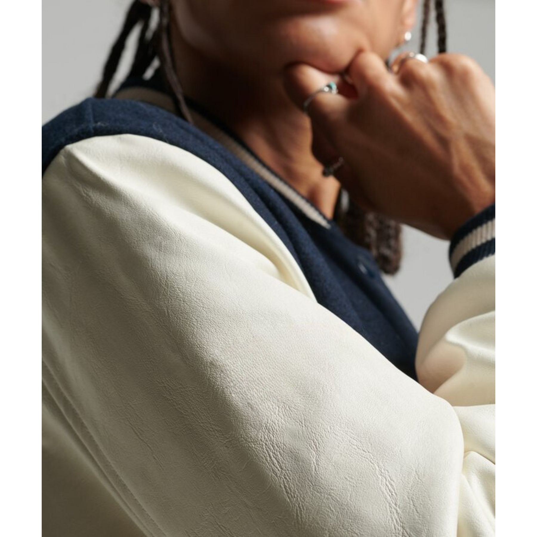 Close-up of white sleeve on navy varsity jacket