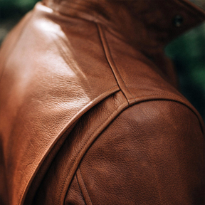 Shoulder stitching on a brown leather rider jacket.