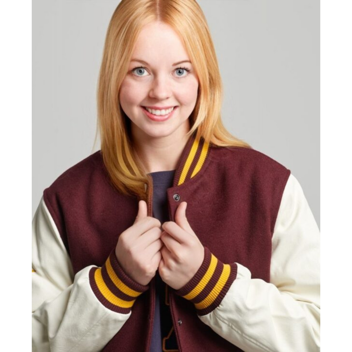 Women's varsity baseball jacket in burgundy with yellow striped cuffs, front view - Alpha Apparel